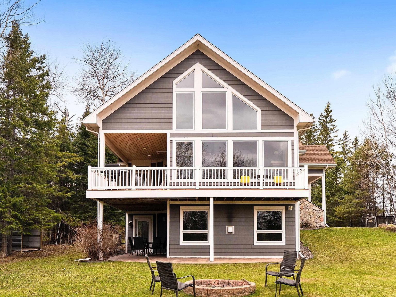 The main lodge from the lawn, with a wraparound deck and tall prow windows